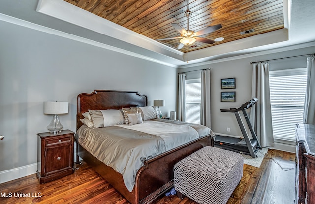 bedroom featuring wood-type flooring, baseboards, a tray ceiling, visible vents, and wood ceiling