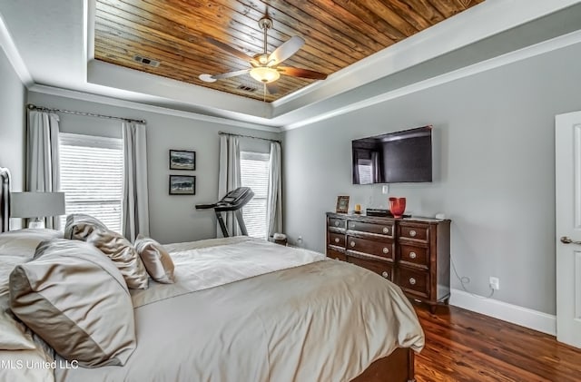 bedroom with dark wood-style flooring, ceiling fan, baseboards, a tray ceiling, and wood ceiling
