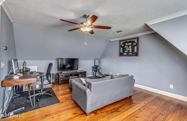 living area featuring visible vents, lofted ceiling, wood finished floors, baseboards, and a ceiling fan