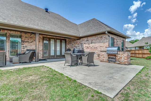 view of patio / terrace featuring area for grilling, fence, french doors, and a grill