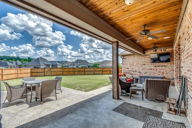 view of patio / terrace featuring a fenced backyard, a ceiling fan, a residential view, and outdoor dining space