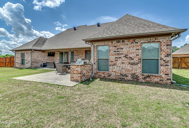 back of house featuring area for grilling, a patio area, brick siding, a fenced backyard, and a yard
