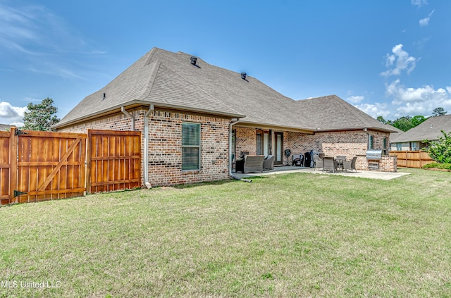 back of house featuring brick siding, a fenced backyard, roof with shingles, and a patio area