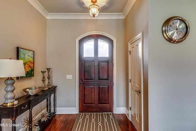 foyer entrance featuring crown molding, baseboards, and dark wood-type flooring