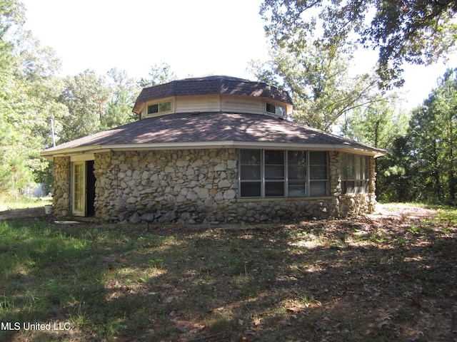 1934 Blue Ridge Rd, Fulton, MS 38843 - view of home's exterior featuring a shingled roof and stone siding