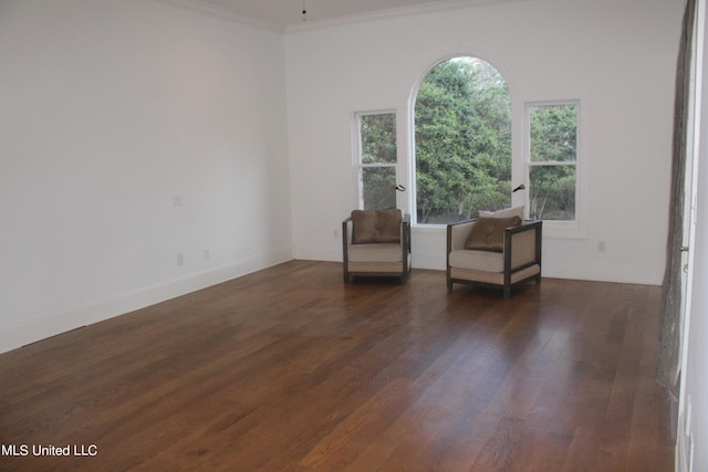 unfurnished room with crown molding and dark hardwood / wood-style flooring