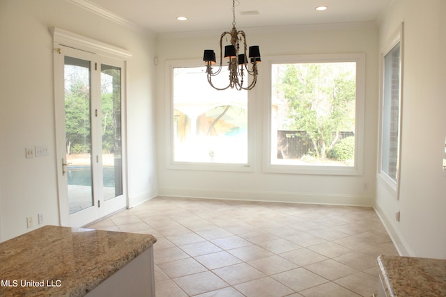 unfurnished dining area featuring crown molding, a healthy amount of sunlight, and light tile patterned flooring