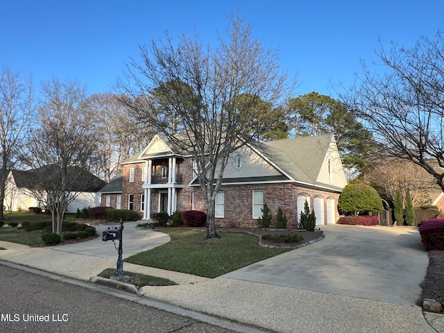 view of front of property with a front lawn, a garage, and a balcony