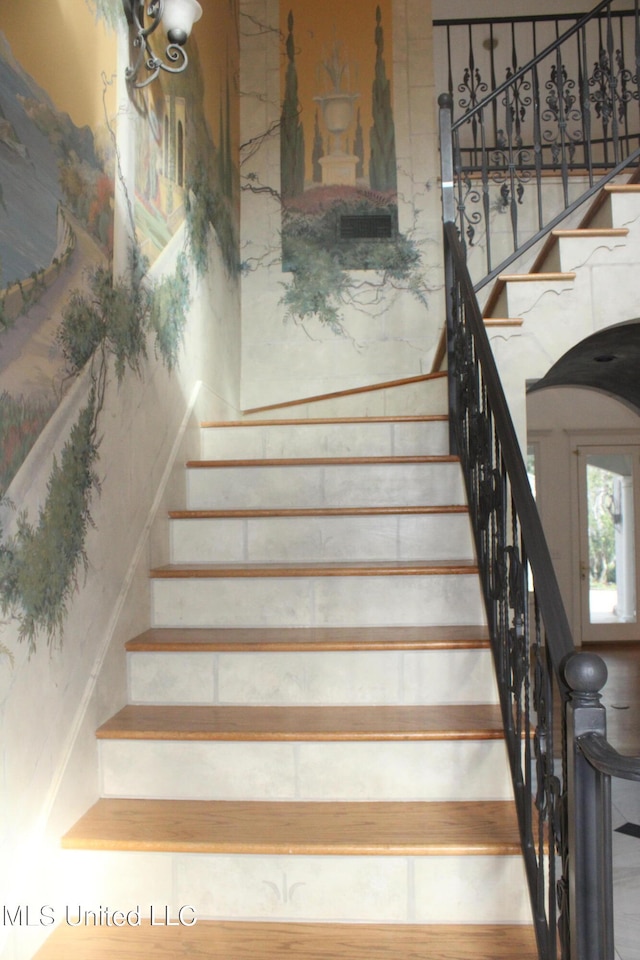 stairs featuring hardwood / wood-style flooring