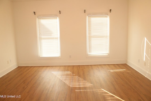 unfurnished room with hardwood / wood-style floors