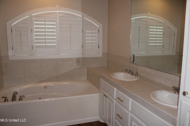 bathroom with vanity and a bath