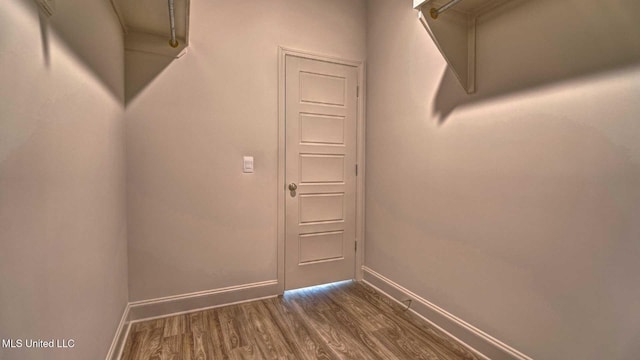 walk in closet featuring dark wood-type flooring