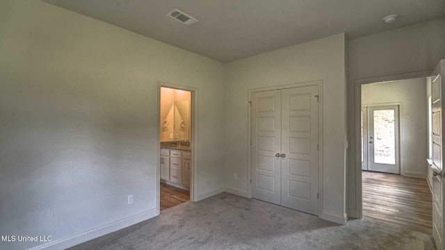 unfurnished bedroom featuring visible vents, a closet, baseboards, and carpet floors