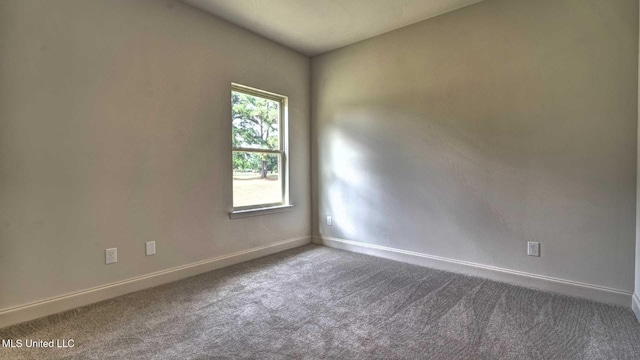 spare room with carpet floors and baseboards