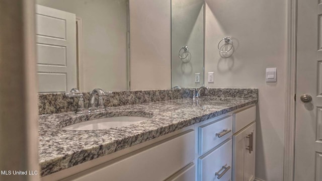 bathroom featuring double vanity and a sink