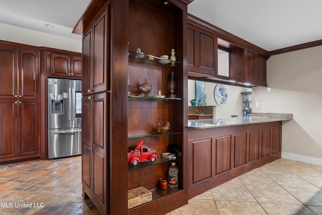 kitchen featuring stainless steel fridge and crown molding