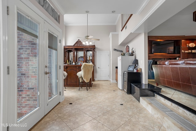 interior space featuring plenty of natural light, ornamental molding, light tile patterned floors, and french doors