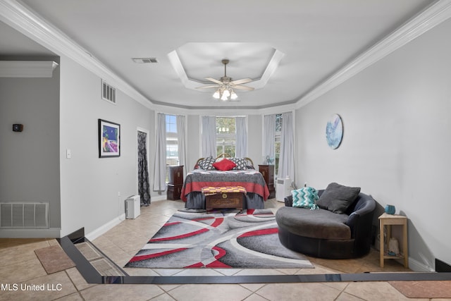 tiled bedroom with a tray ceiling, ceiling fan, and ornamental molding