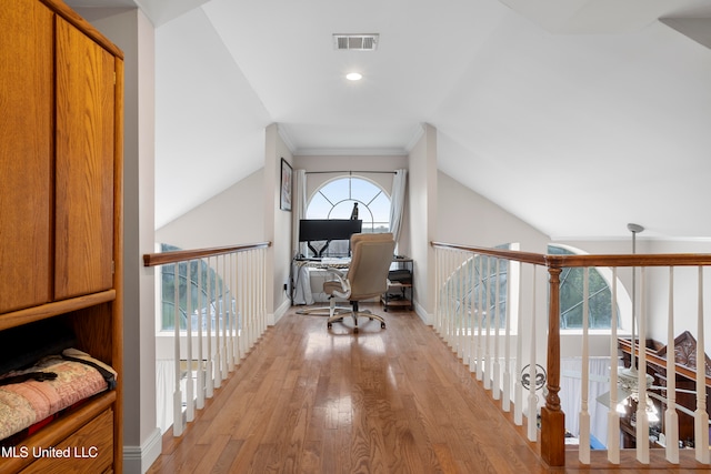 hallway with lofted ceiling and light wood-type flooring