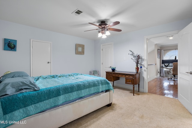 bedroom with ceiling fan and light colored carpet