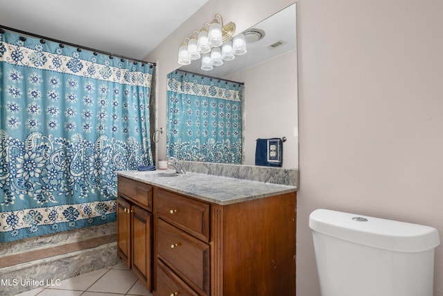 bathroom featuring tile patterned flooring, vanity, and toilet