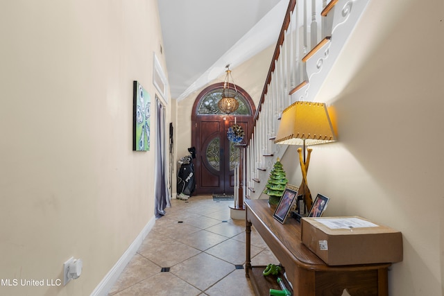 tiled entrance foyer with a towering ceiling