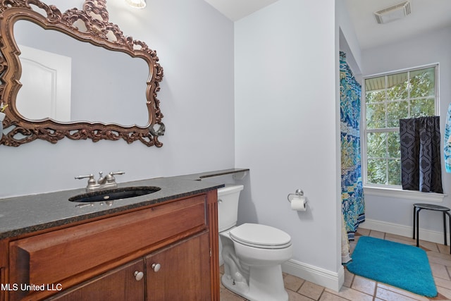 bathroom with tile patterned floors, vanity, and toilet