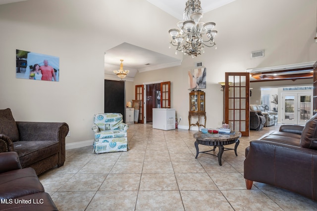 tiled living room featuring an inviting chandelier, crown molding, and french doors