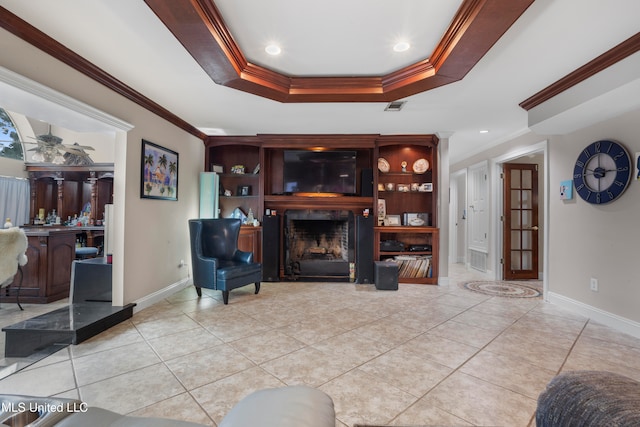 living room with a tray ceiling, crown molding, and light tile patterned floors