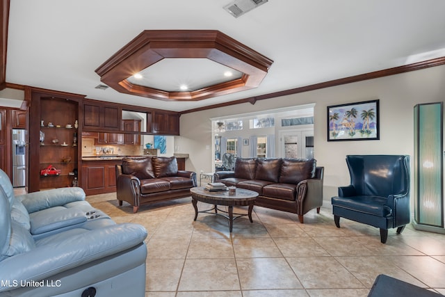 living room with a raised ceiling, light tile patterned flooring, and ornamental molding