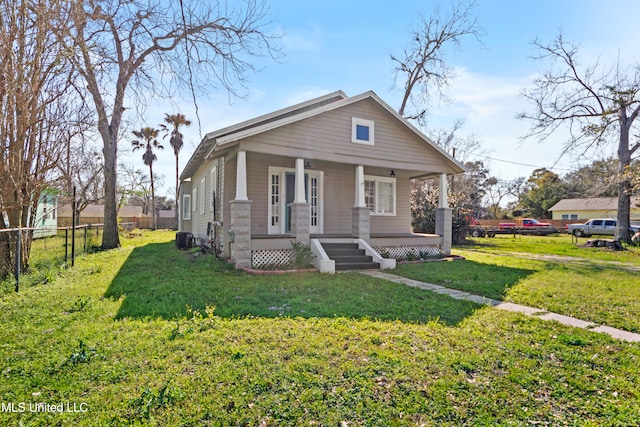 bungalow with a front lawn, fence, and covered porch