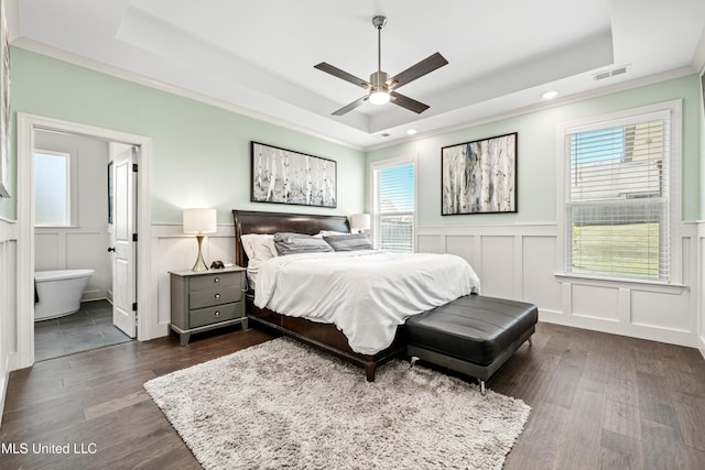 4432 John Wood Ln, Olive Branch, MS 38654 - bedroom featuring a raised ceiling, a decorative wall, multiple windows, a wainscoted wall, and dark wood-style floors