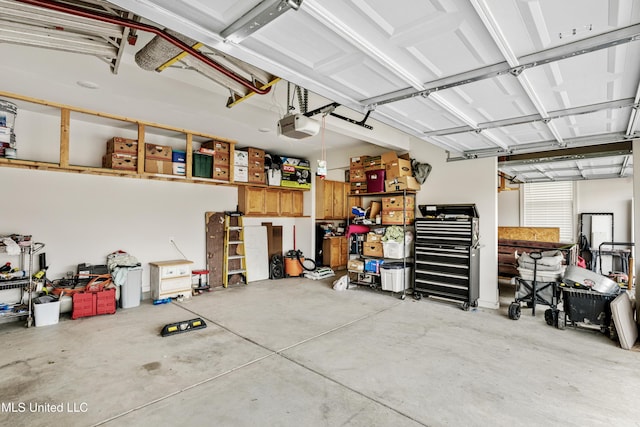 4432 John Wood Ln, Olive Branch, MS 38654 - garage with a garage door opener and a workshop area