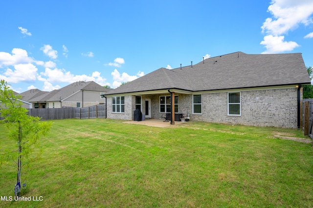 4432 John Wood Ln, Olive Branch, MS 38654 - back of property featuring a patio, a fenced backyard, brick siding, and a shingled roof