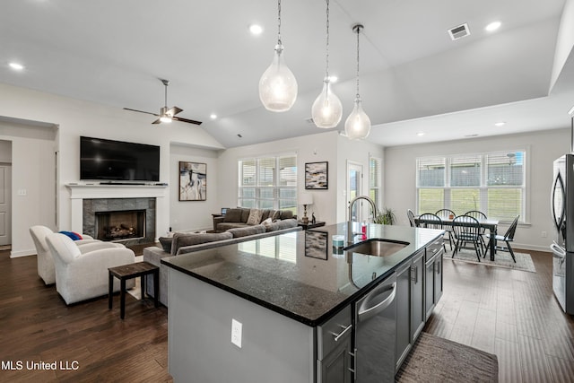 4432 John Wood Ln, Olive Branch, MS 38654 - kitchen featuring appliances with stainless steel finishes, ceiling fan, dark wood finished floors, lofted ceiling, and dark stone counters