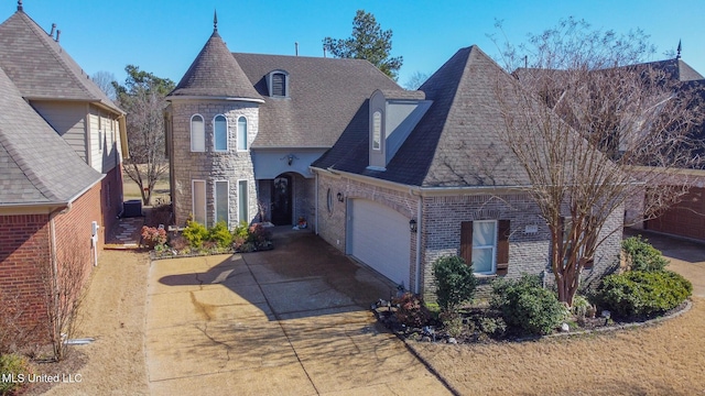 view of front facade with an attached garage, brick siding, a shingled roof, concrete driveway, and stone siding