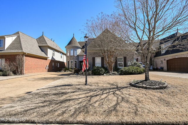 view of front facade with brick siding and driveway