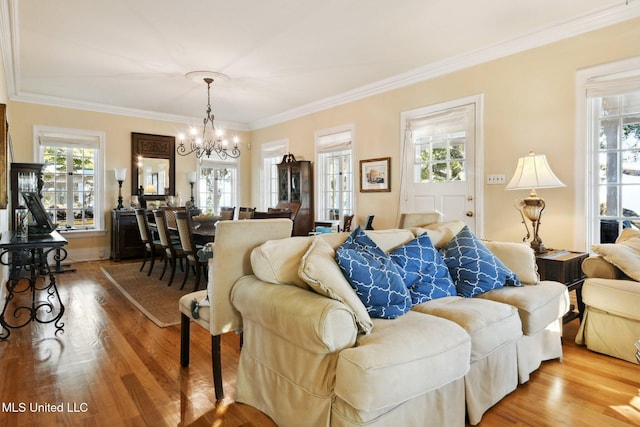600 N Beach Blvd, Bay Saint Louis, MS 39520 - living room featuring healthy amount of natural light, a chandelier, crown molding, and wood finished floors