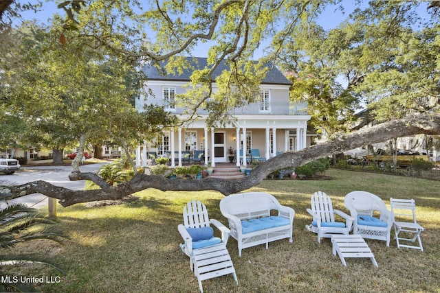 600 N Beach Blvd, Bay Saint Louis, MS 39520 - back of house with a porch, a lawn, and roof with shingles