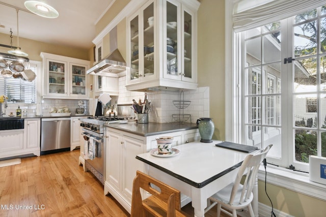 600 N Beach Blvd, Bay Saint Louis, MS 39520 - kitchen with appliances with stainless steel finishes, tasteful backsplash, and white cabinetry