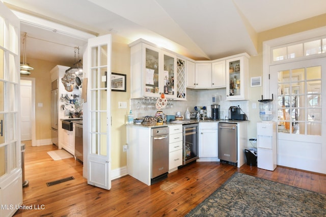 600 N Beach Blvd, Bay Saint Louis, MS 39520 - kitchen featuring beverage cooler, backsplash, white cabinetry, hardwood / wood-style flooring, and lofted ceiling