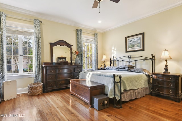 600 N Beach Blvd, Bay Saint Louis, MS 39520 - bedroom featuring wood finished floors, multiple windows, ornamental molding, and a ceiling fan