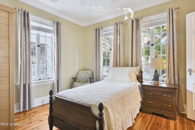 600 N Beach Blvd, Bay Saint Louis, MS 39520 - bedroom with wood finished floors, ornamental molding, and a ceiling fan