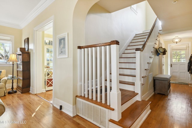 600 N Beach Blvd, Bay Saint Louis, MS 39520 - stairway with plenty of natural light, wood finished floors, ornamental molding, and arched walkways