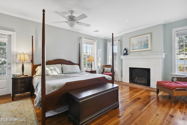 600 N Beach Blvd, Bay Saint Louis, MS 39520 - bedroom featuring wood-type flooring, a brick fireplace, and crown molding