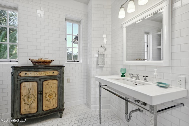 600 N Beach Blvd, Bay Saint Louis, MS 39520 - bathroom featuring tile walls, healthy amount of natural light, and tile patterned floors