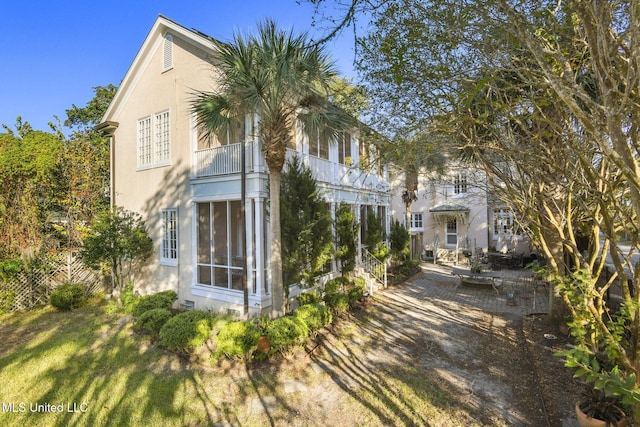 600 N Beach Blvd, Bay Saint Louis, MS 39520 - rear view of property featuring a balcony and a sunroom
