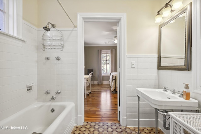 600 N Beach Blvd, Bay Saint Louis, MS 39520 - bathroom featuring shower / bathtub combination, ceiling fan, and wainscoting