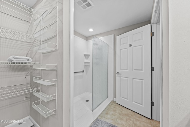 bathroom with a walk in shower, tile patterned flooring, recessed lighting, and visible vents