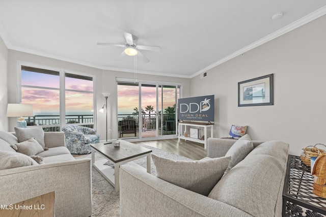 living area featuring ceiling fan, visible vents, ornamental molding, and wood finished floors
